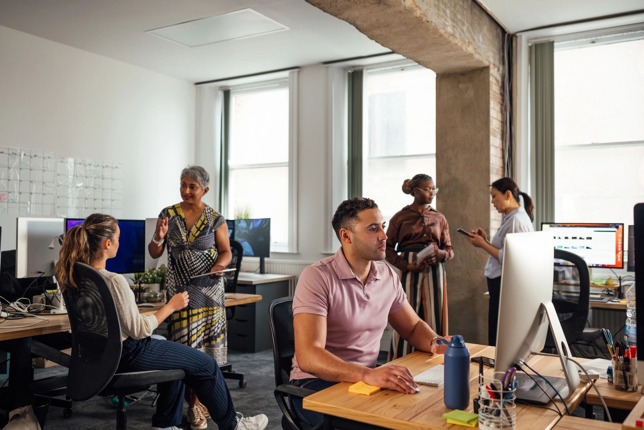 Technology support staff collaborating in an office